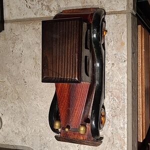 A handmade car made out of wood mostly as I can tell painted nicely this